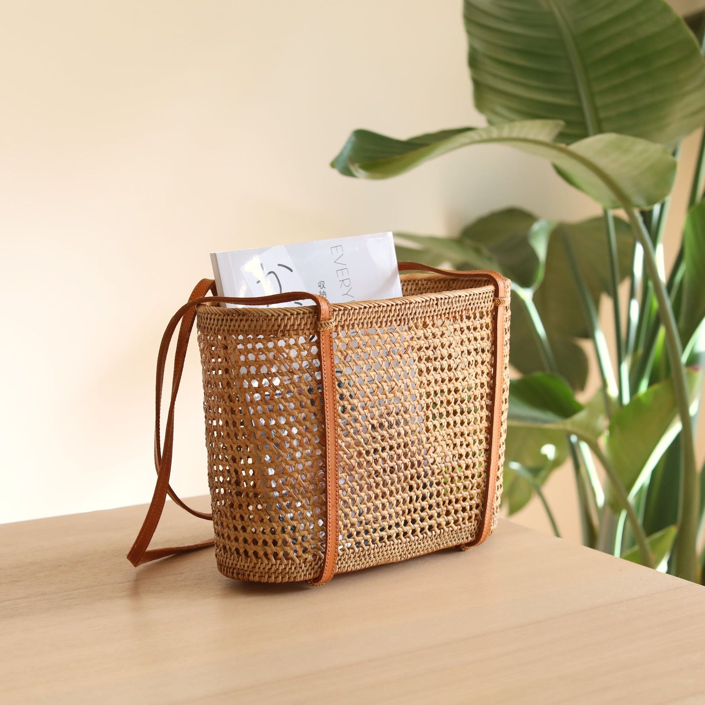 The Bali Rattan Woven Tote Bag handmade by Ganapati Crafts Co. in Bali where all the Rattan Bags are made is sitting on a table