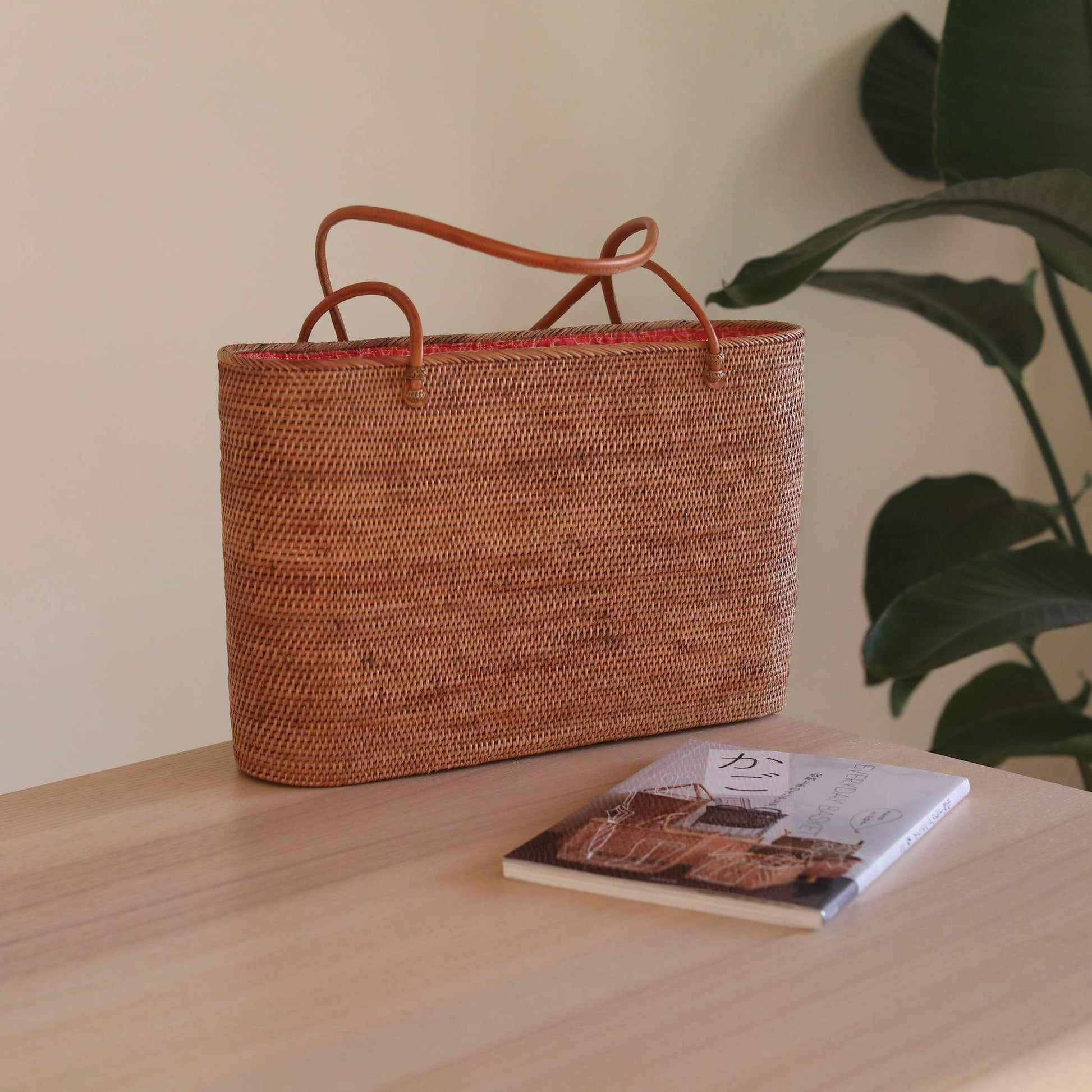Bali Rattan Grand Shoulder Bag handmade by Ganapati Crafts Co. in Bali is sitting on a table looking stylish