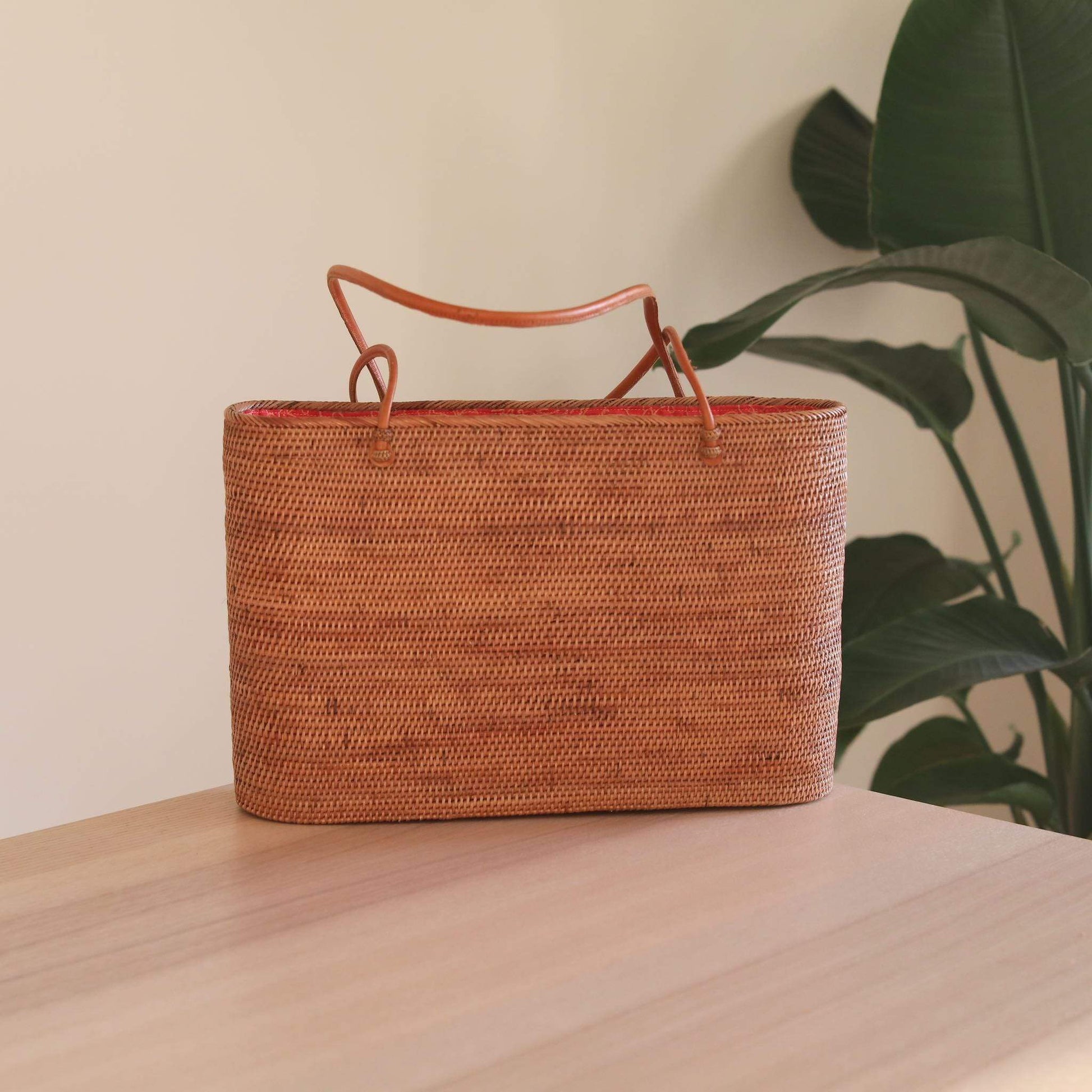 Bali Rattan Grand Shoulder Bag handmade by Ganapati Crafts Co. in Bali is sitting on a table looking stylish