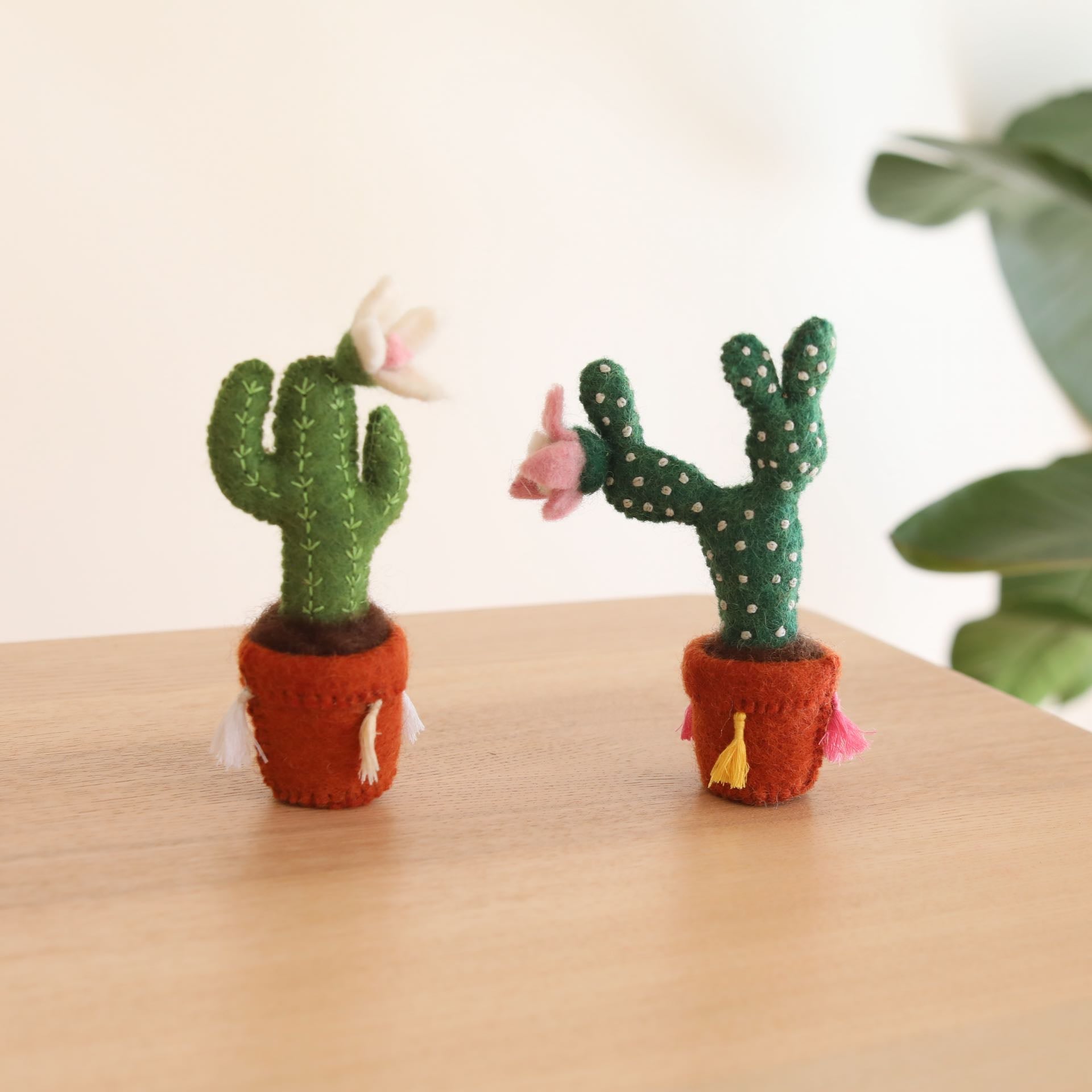 The cute felt potted prickly pear cactus is hand-made in Nepal using organic wool and eco-friendly dyes. The cactus is needle felted individually. The felt terracotta pot is decorated with colorful tassels. It is 3D designed to look great at any angle. Perfect gift for cactus lovers and it's a wonderful decor for the nursery.