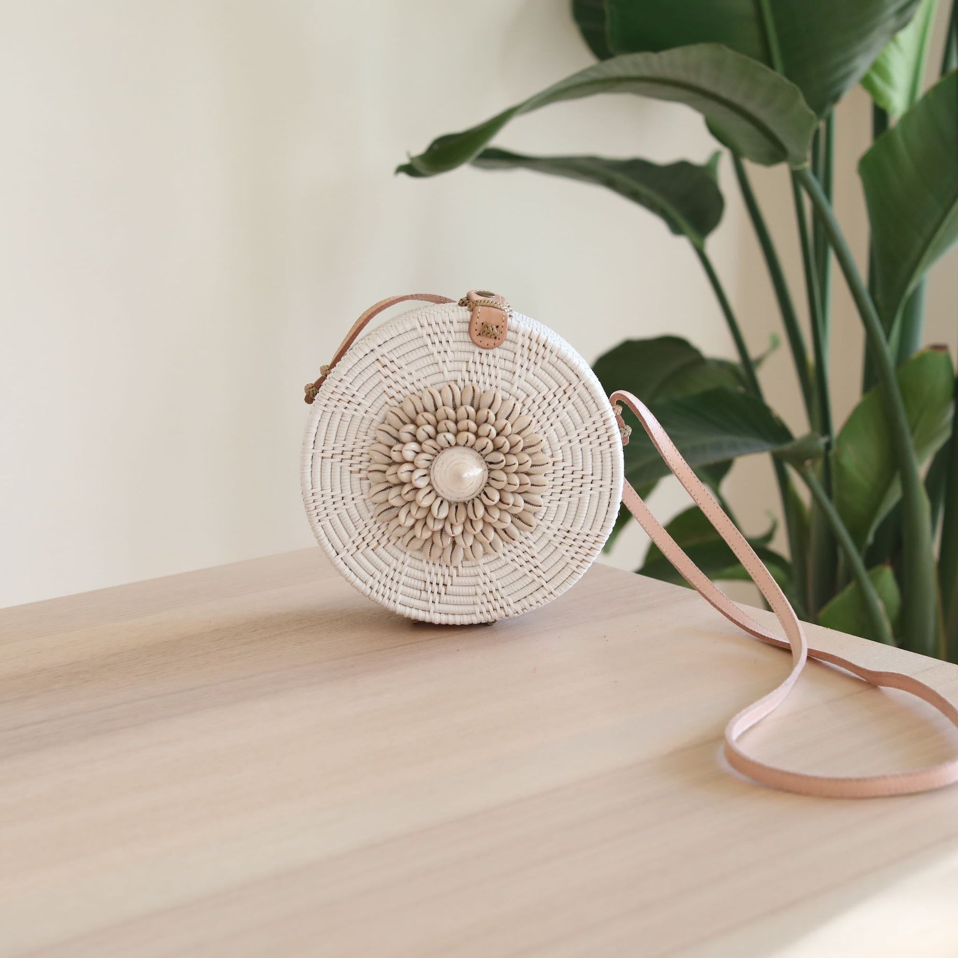 White Bali Round Rattan Bag with Seashell Embellishment. Handmade in Bali by Ganapati Crafts Co.